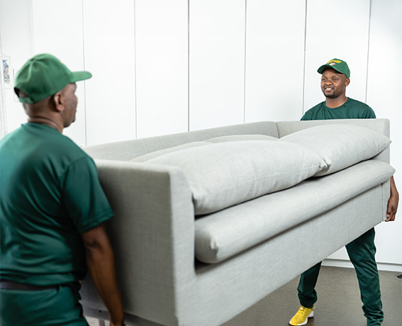Stuttaford Van Lines professional movers carefully carrying a sofa during a household move.